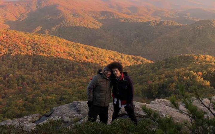 two gap year students smile for a photo on an overlook of the blue ridge mountains 